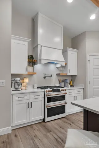 a view of a livingroom with furniture and hardwood floor