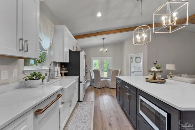 a kitchen with stainless steel appliances a refrigerator and cabinets