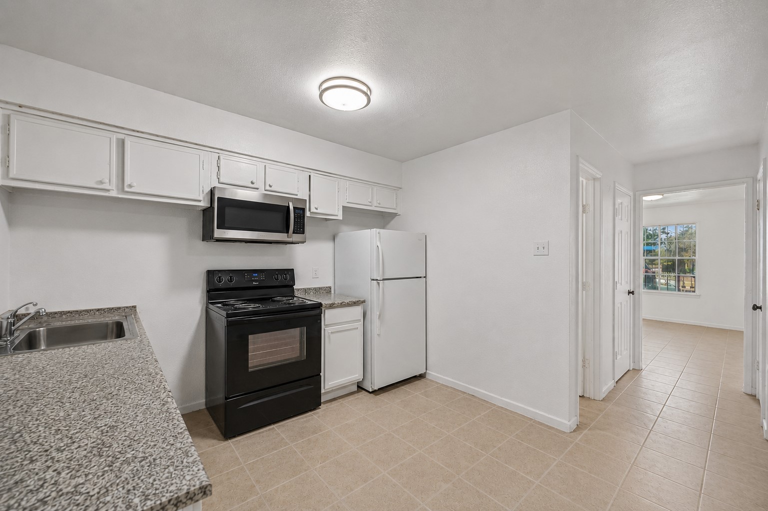 12054 Beechnut Street Houston, TX 77072 - Photo 7 of 21 a kitchen with stainless steel appliances granite countertop a stove a sink and a refrigerator