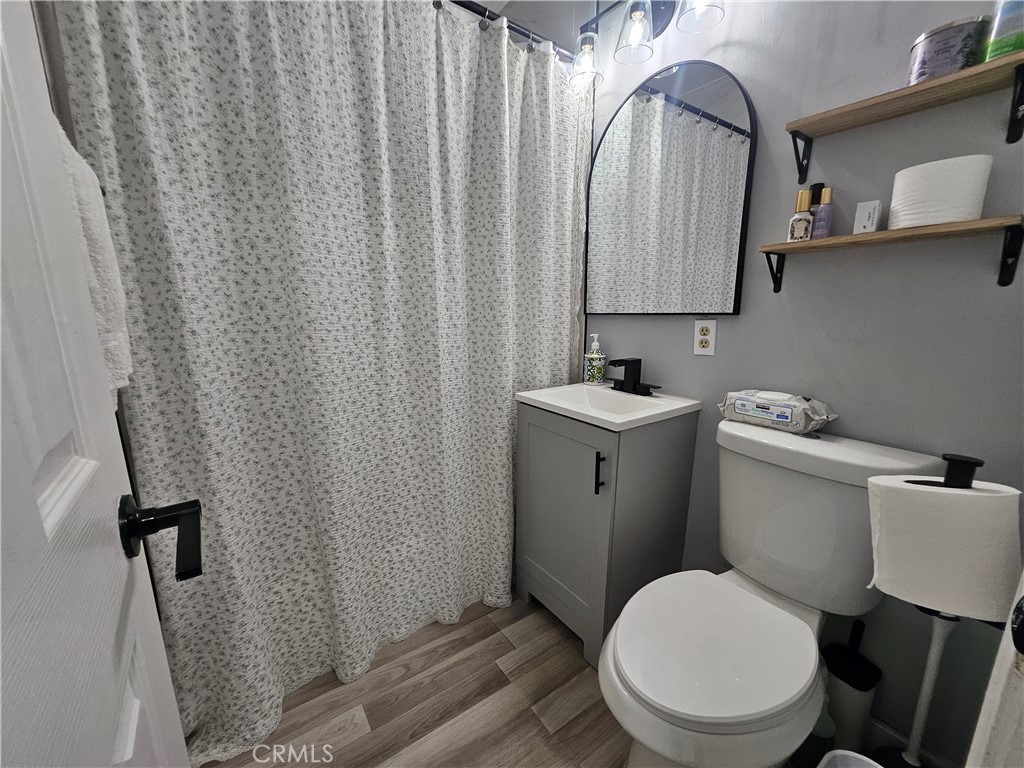 629 West Plum Street Compton, CA 90222 - Photo 12 of 15 a bathroom with a toilet sink and mirror