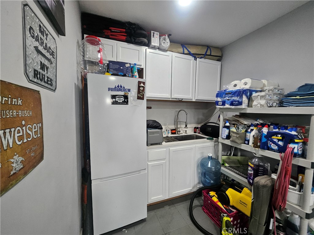 629 West Plum Street Compton, CA 90222 - Photo 13 of 15 a kitchen with a refrigerator and cabinets