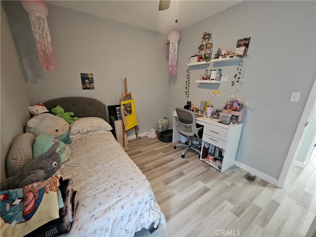 629 West Plum Street Compton, CA 90222 - Photo 9 of 15 a bedroom with a bed and wooden floor