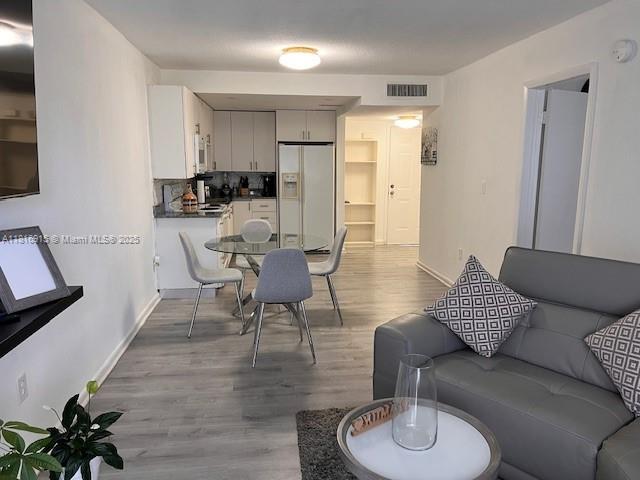 677 Southwest 9th Avenue, Unit 303 Miami, FL 33130 - Photo 20 of 34 a living room with furniture and a wooden floor