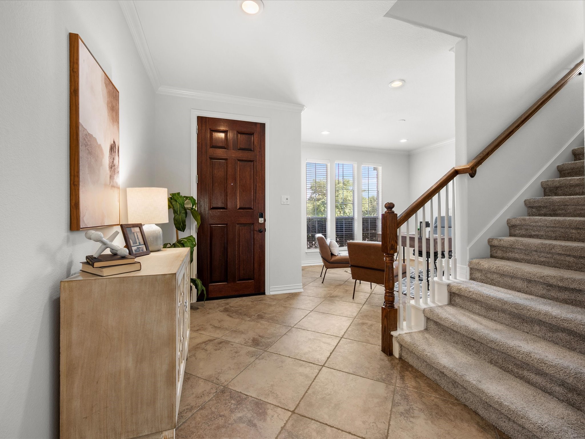323 Arbor Ridge Lane Conroe, TX 77384 - Photo 6 of 40 Step inside and it just breathes. Wide entry, natural light pouring in, and a layout that pulls you straight toward the back of the house. The kind of welcome that makes people slow down.
