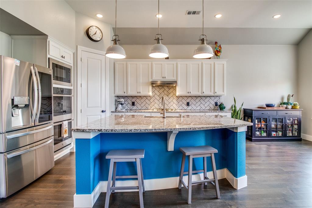 1008 Faringdon Drive Anna, TX 75409 - Photo 1 of 1 a kitchen with stainless steel appliances granite countertop a sink a stove and a refrigerator