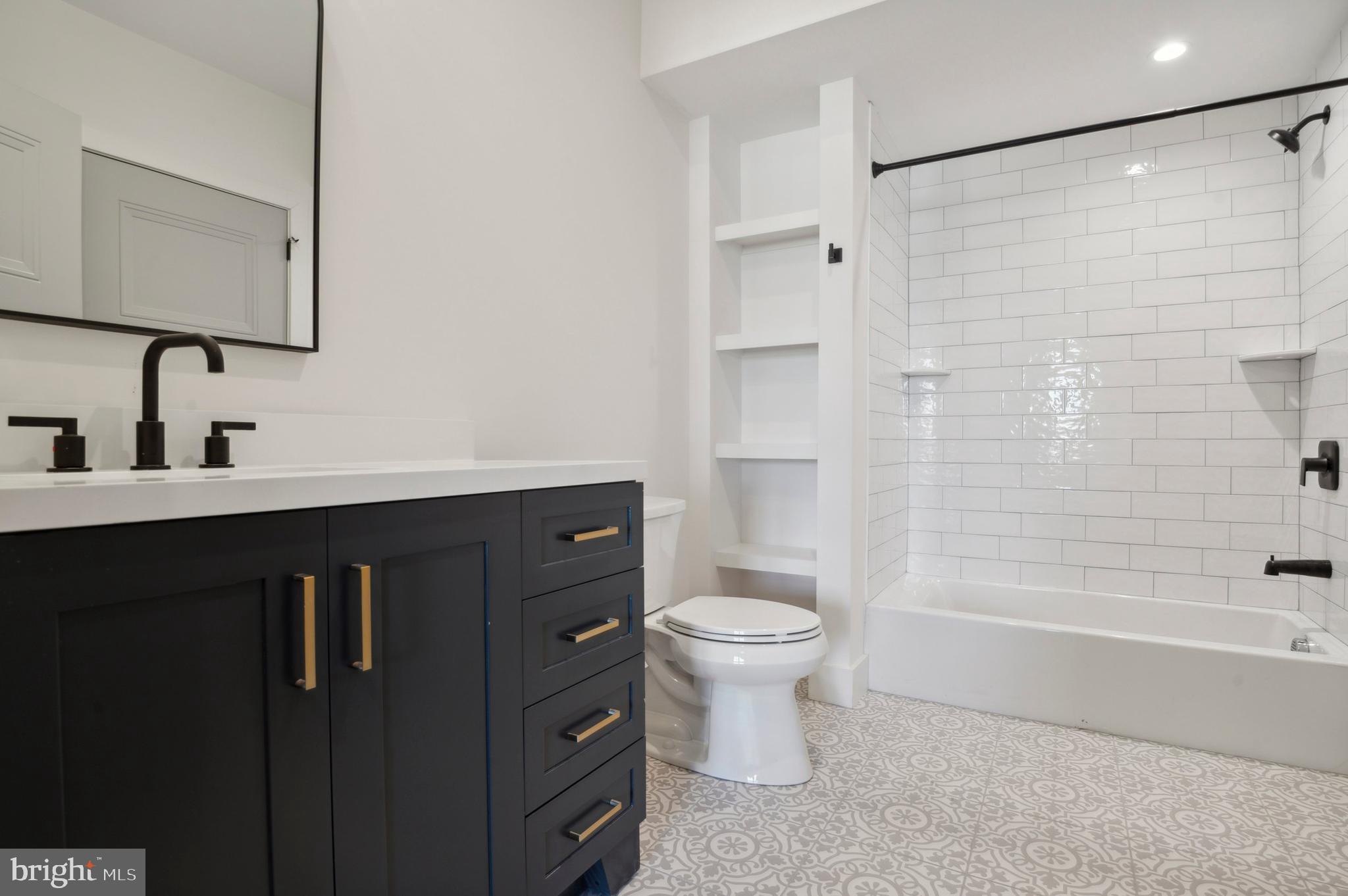 35 Chestnut Road, Unit 204 Paoli, PA 19301 - Photo 5 of 13 a bathroom with a sink toilet a mirror and shower