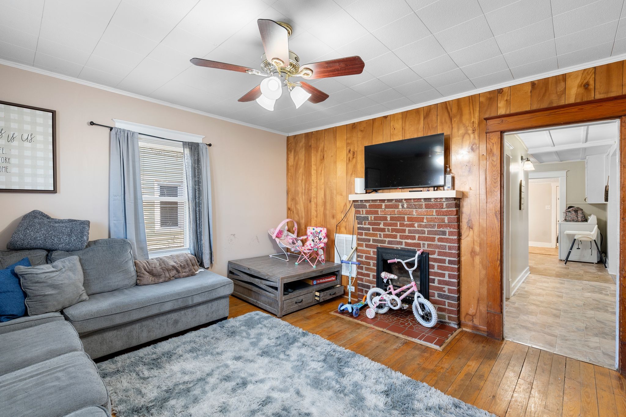 1710 County Hospital Road Nashville, TN 37218 - Photo 4 of 27 a living room with furniture a fireplace and a flat screen tv