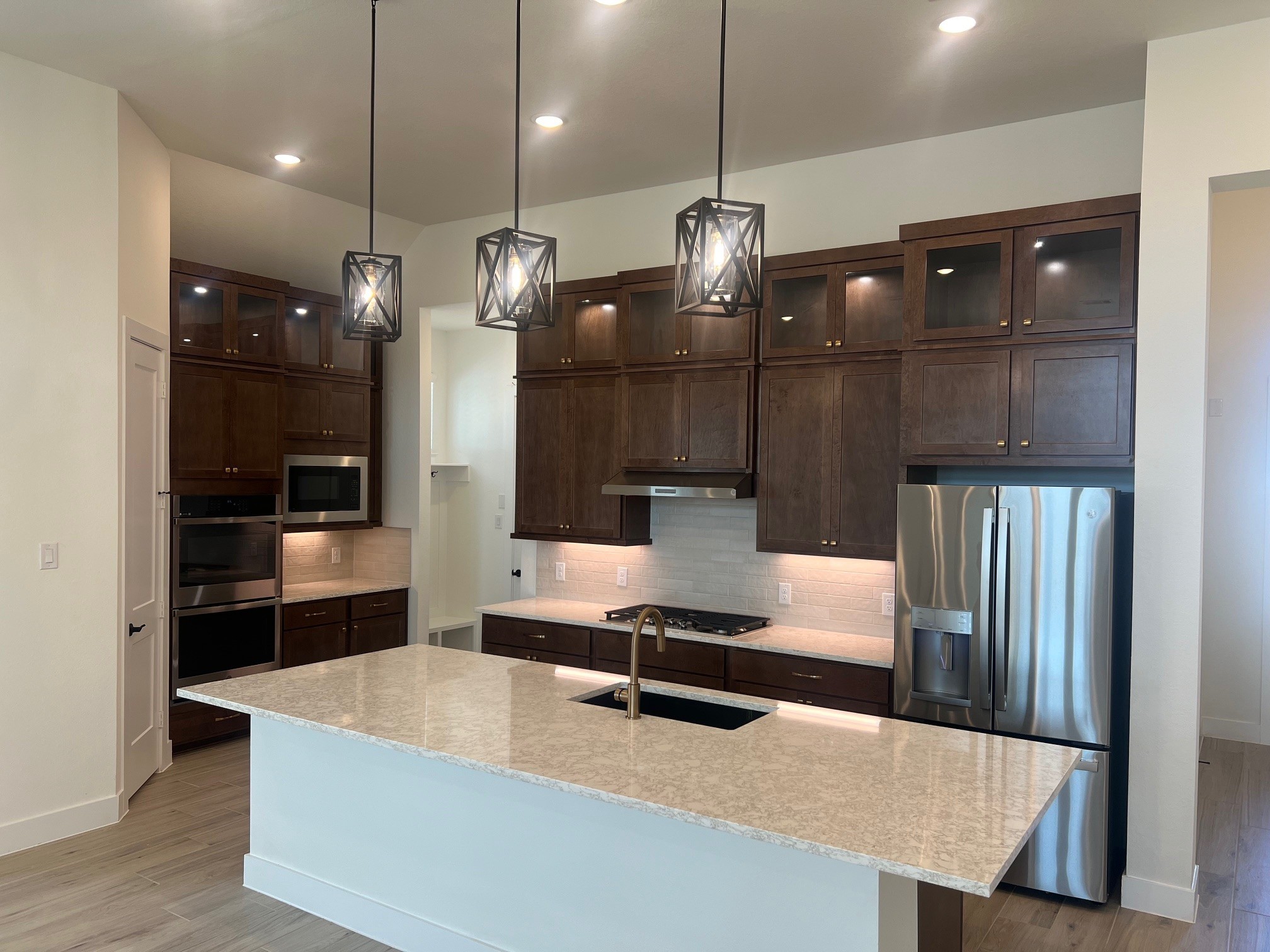 13331 Valley Orchard Tomball, TX 77375 - Photo 3 of 30 a large kitchen with stainless steel appliances kitchen island a refrigerator and a wooden floors