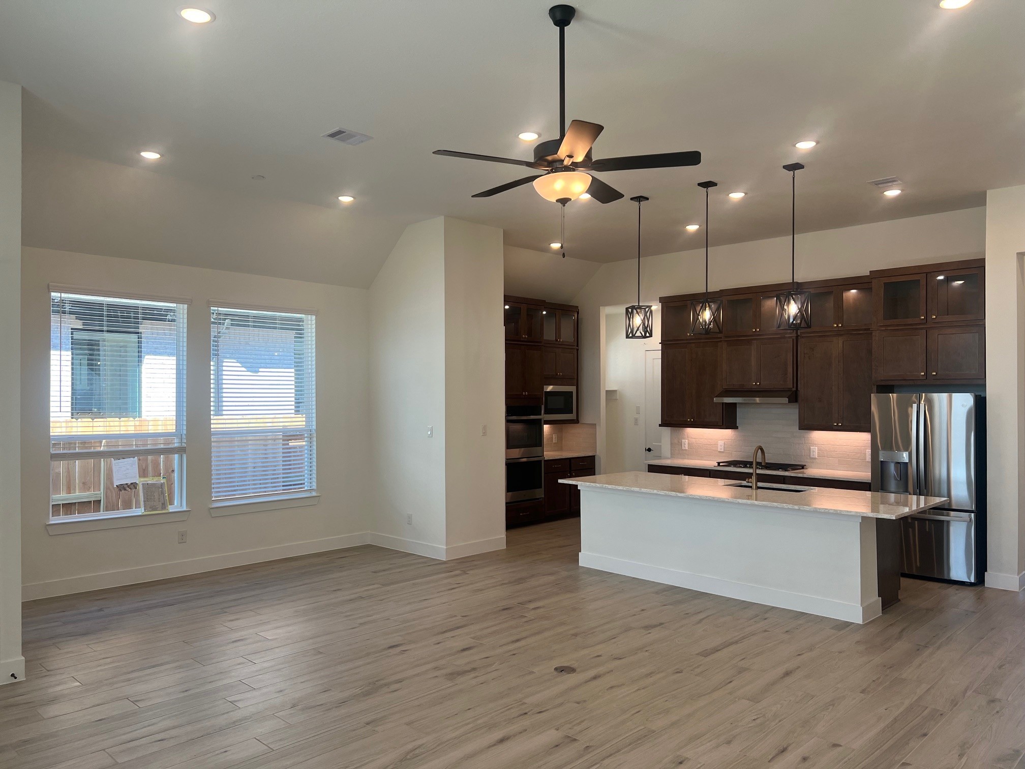 13331 Valley Orchard Tomball, TX 77375 - Photo 5 of 30 a large kitchen with stainless steel appliances kitchen island a large island in the center