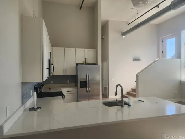 a kitchen with a sink and a stove top oven