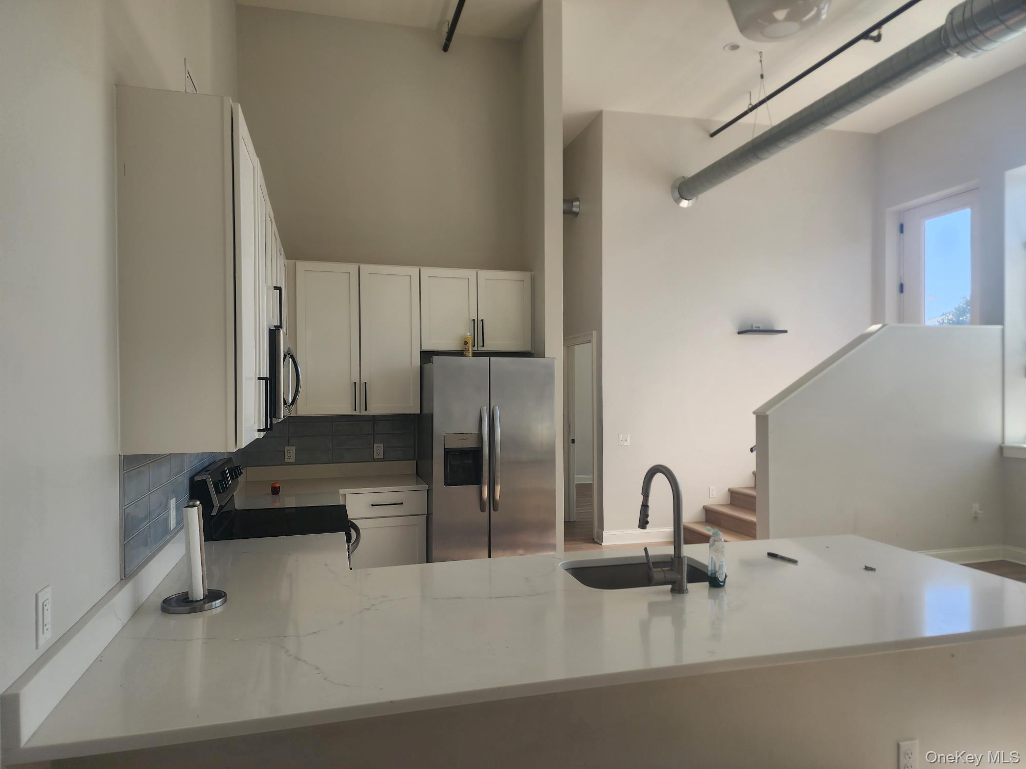 a kitchen with a sink and a stove top oven