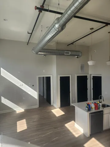 a living room with stainless steel appliances kitchen island granite countertop furniture and a fireplace