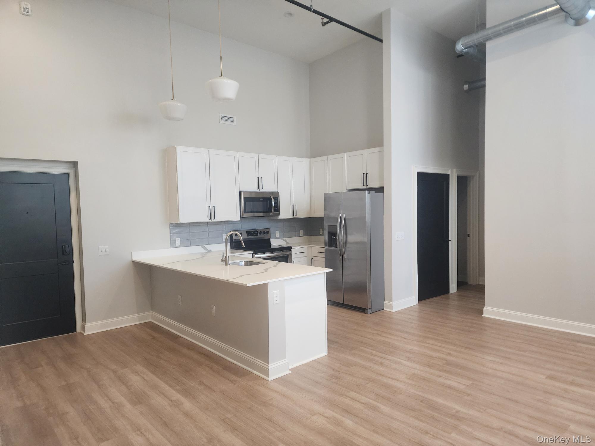 17-anya Court, Unit 301 Poughkeepsie, NY 12603 - Photo 9 of 9 a kitchen with stainless steel appliances a refrigerator and a stove top oven