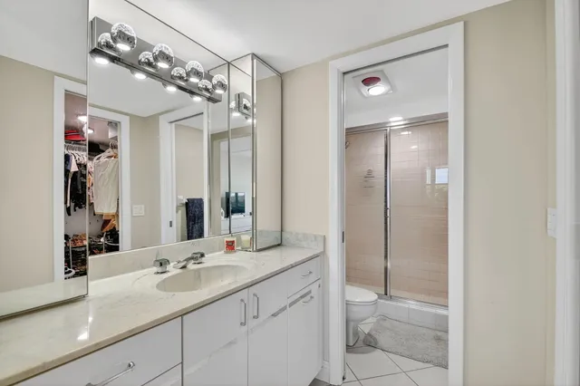 a bathroom with a shower sink and mirror