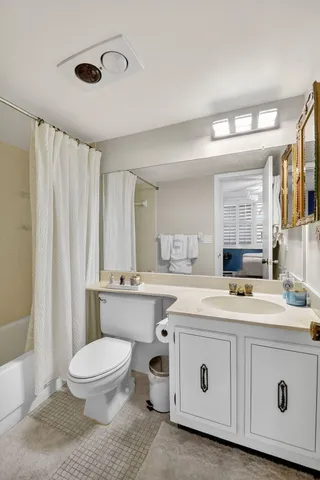 a bathroom with a double vanity sink toilet and shower