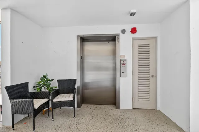 a view of a room with furniture and a potted plant