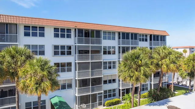 a front view of a building with a garden