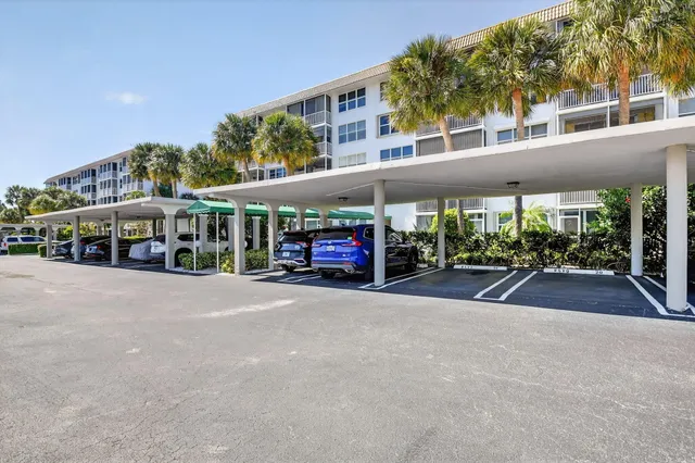 a couple of cars parked in front of a building