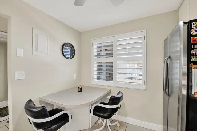a view of a dining room with furniture and a window