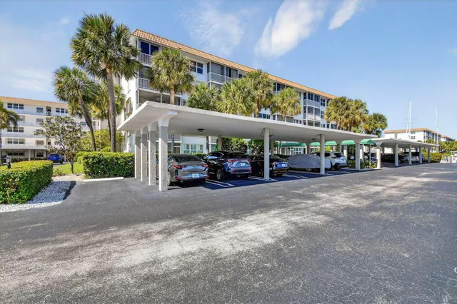 a couple of cars parked in front of a building