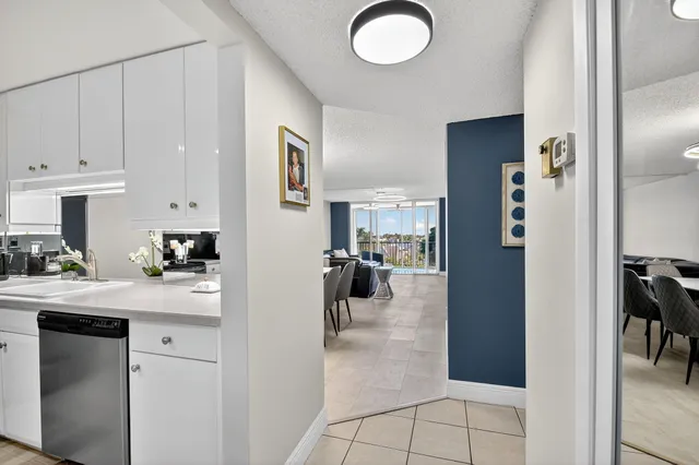 a kitchen with a refrigerator and a sink
