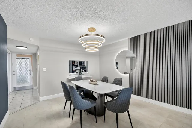 a view of a dining room with furniture and a chandelier