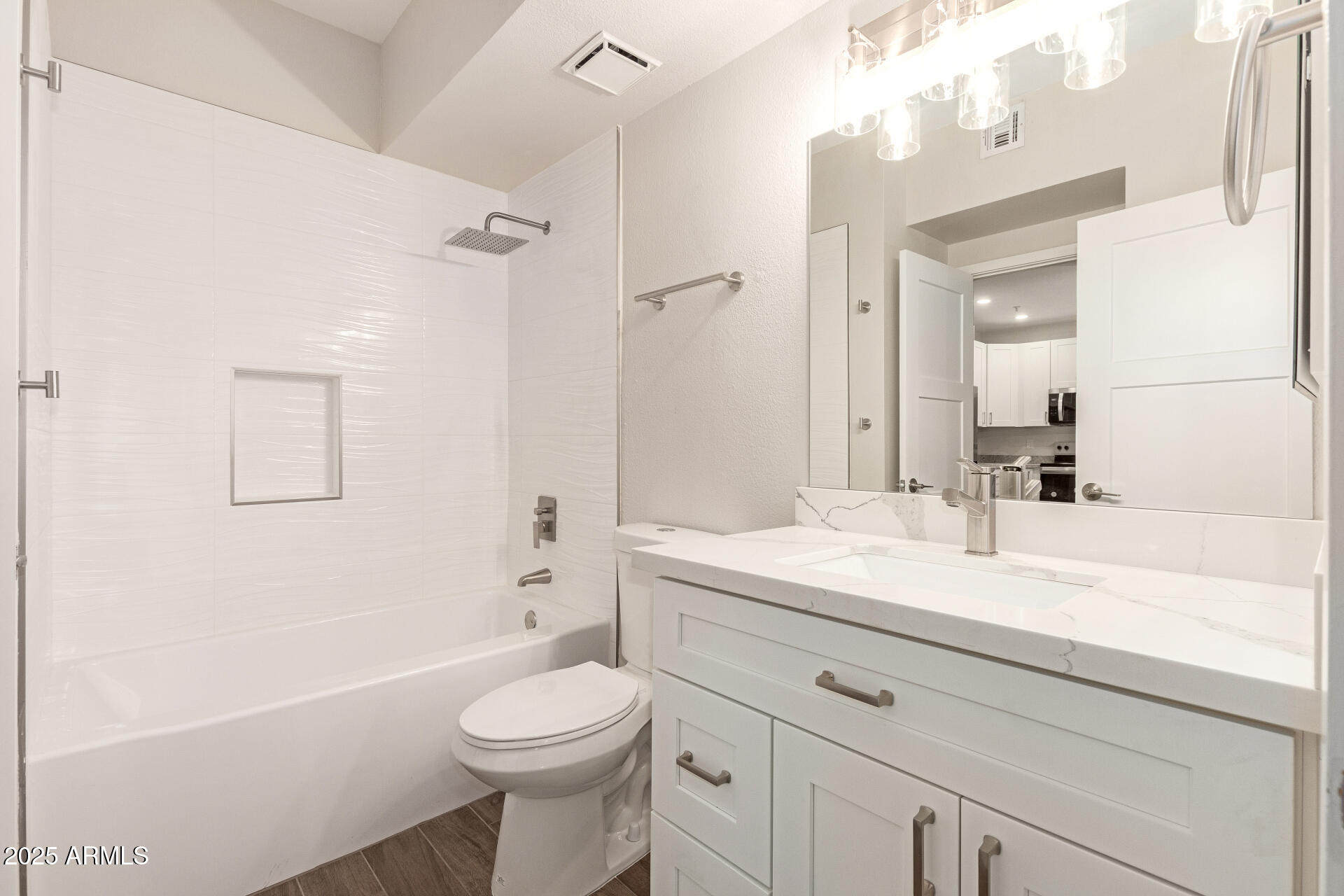 7700 East Gainey Ranch Road, Unit 102 Scottsdale, AZ 85258 - Photo 22 of 40 a bathroom with a sink a toilet a mirror and shower