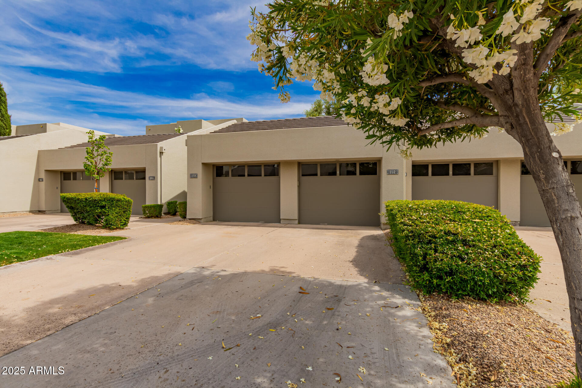 7700 East Gainey Ranch Road, Unit 102 Scottsdale, AZ 85258 - Photo 26 of 40 a front view of a house with garden