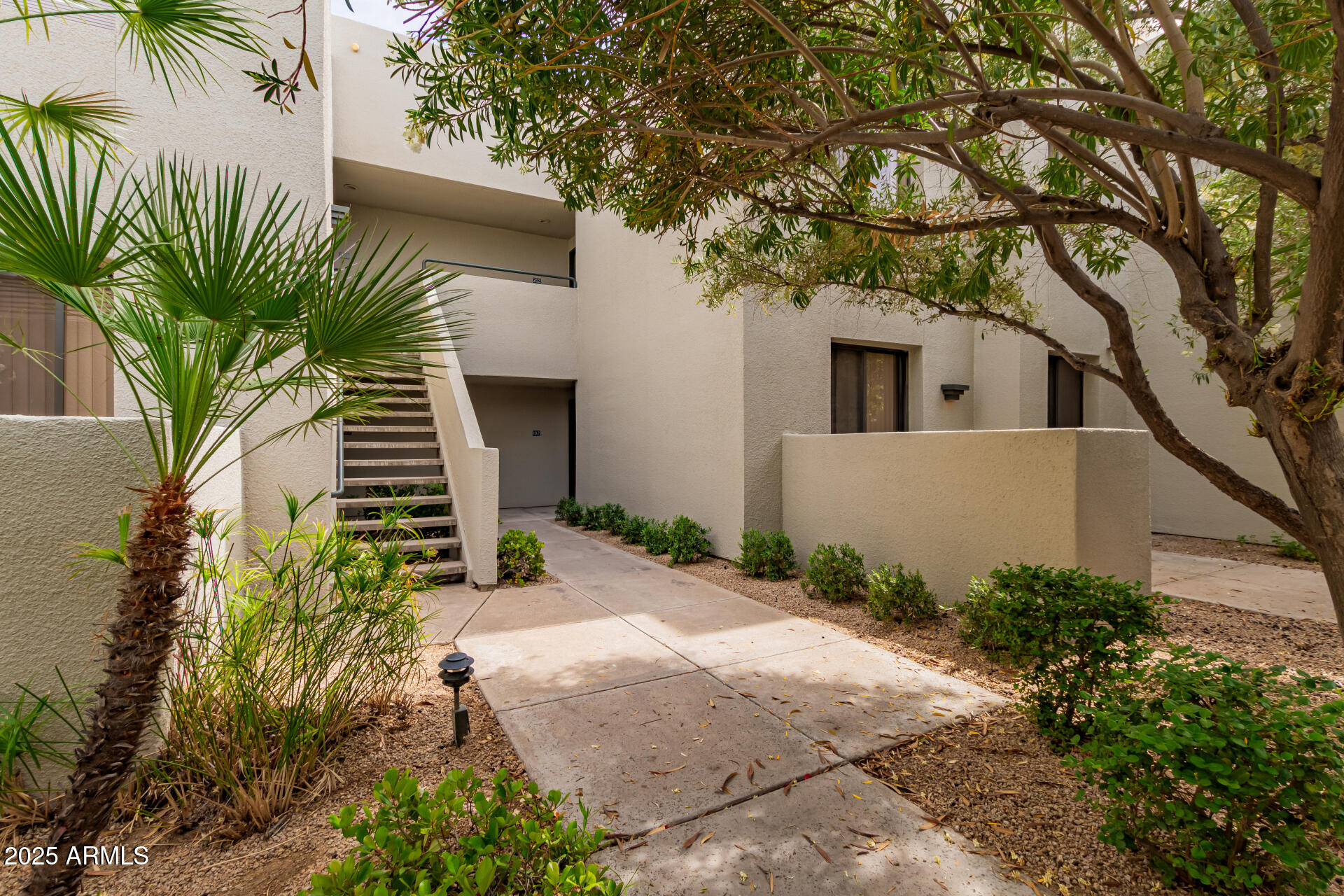 7700 East Gainey Ranch Road, Unit 102 Scottsdale, AZ 85258 - Photo 2 of 40 a house that has a tree in front of the house