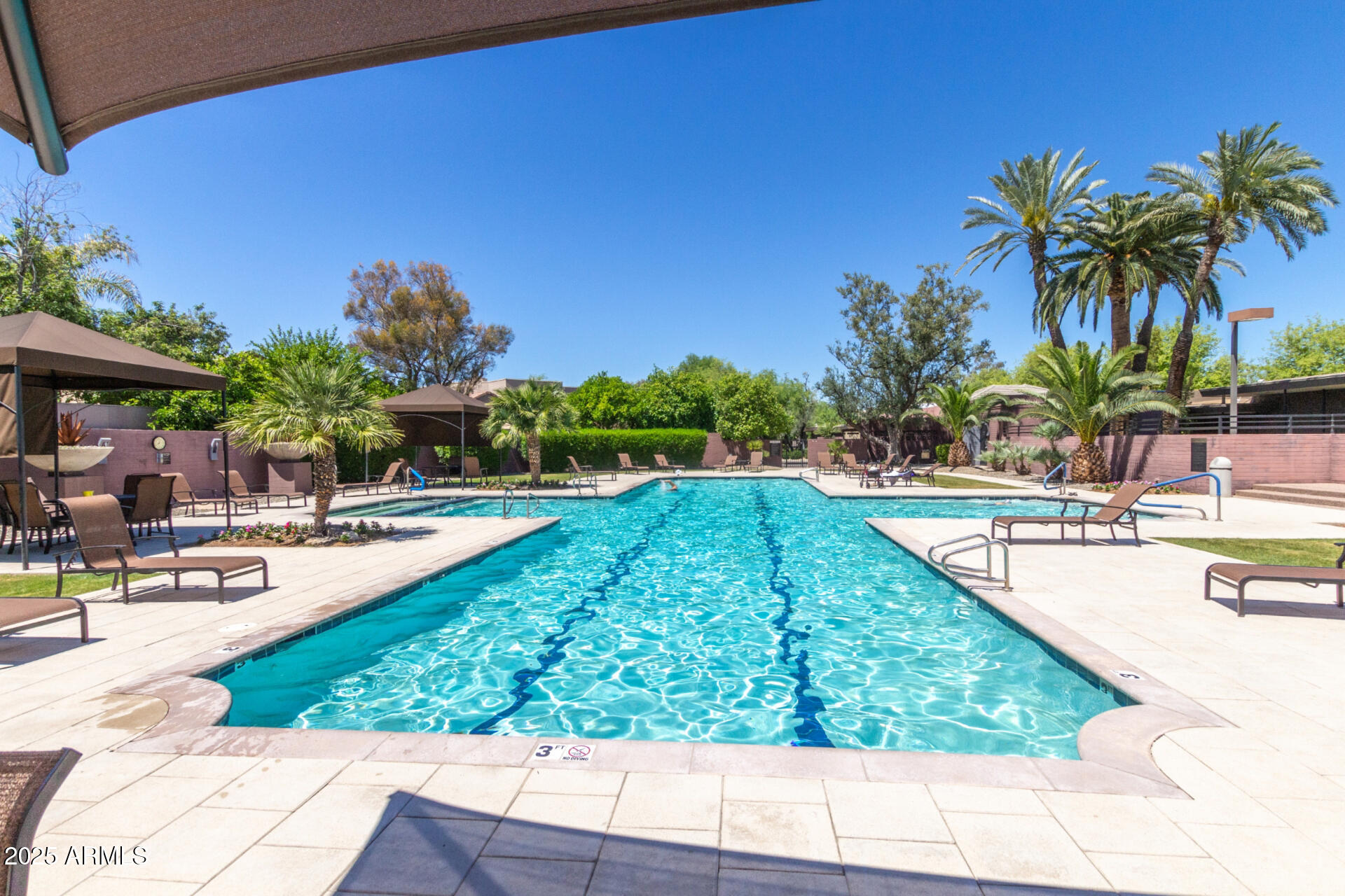 7700 East Gainey Ranch Road, Unit 102 Scottsdale, AZ 85258 - Photo 31 of 40 a swimming pool with outdoor seating and yard