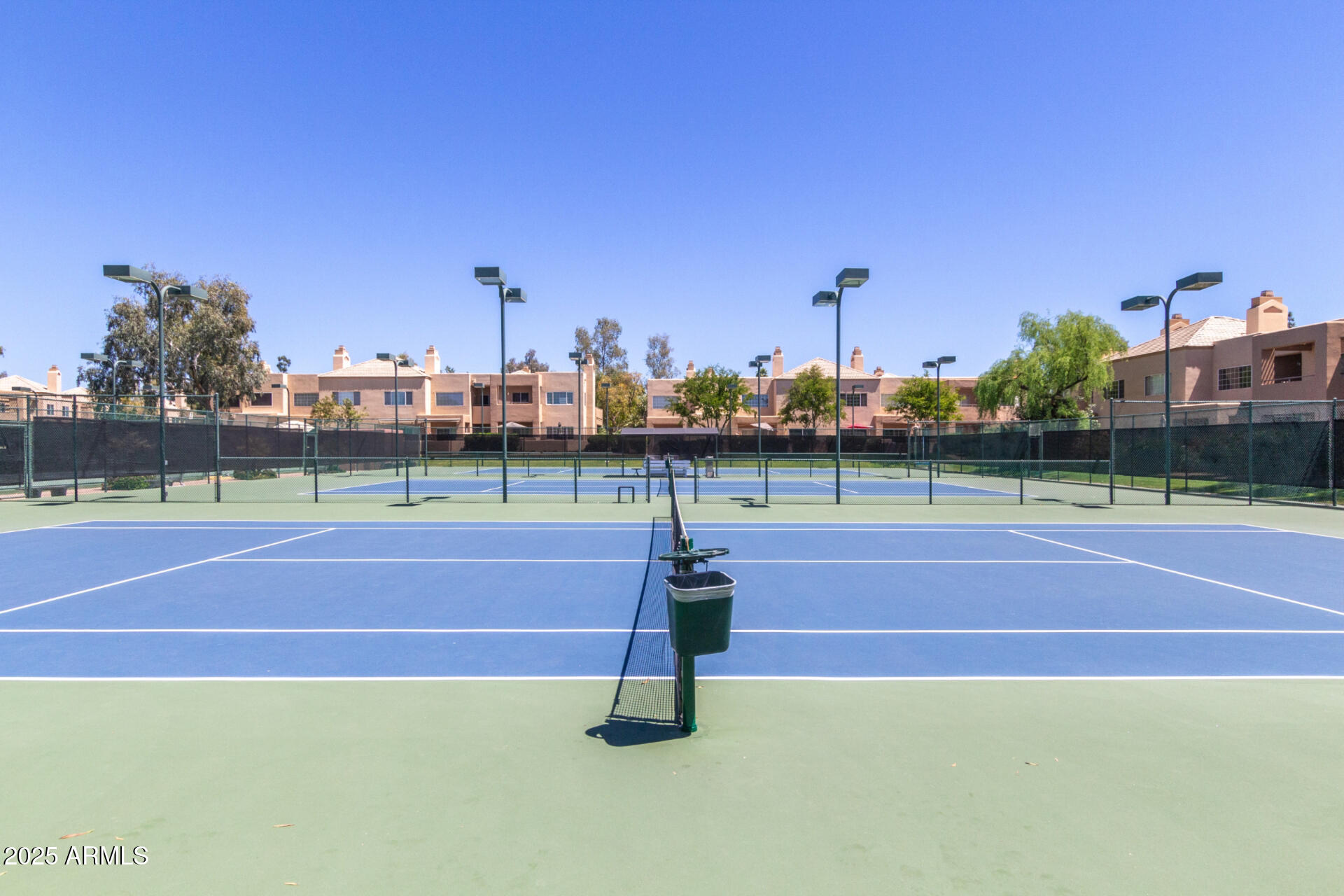 7700 East Gainey Ranch Road, Unit 102 Scottsdale, AZ 85258 - Photo 35 of 40 a tennis court that has trees in the background