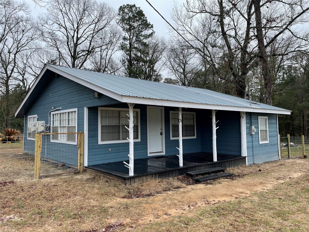 111 Cronin Road Shepherd, TX 77371 - Photo 1 of 16 a view of a house with a yard and large tree