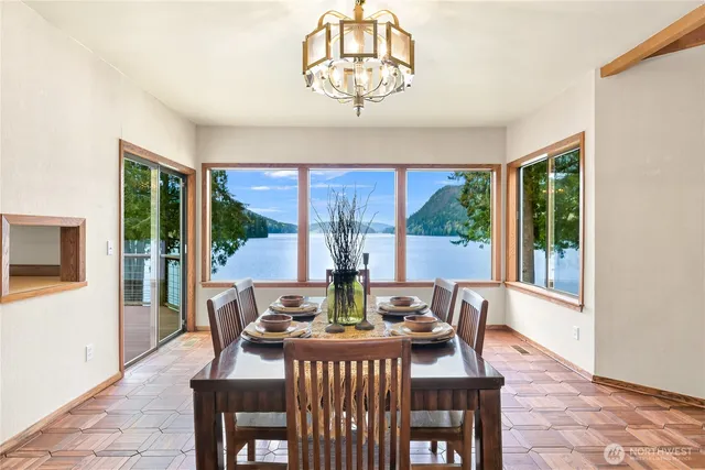 a view of a dining room with furniture large windows and wooden floor