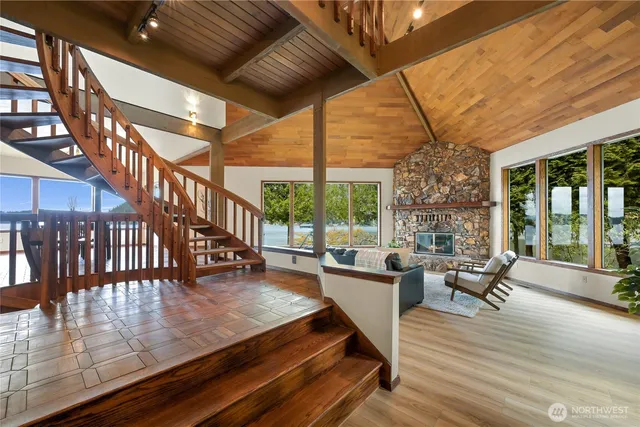 a living room with furniture a chandelier and wooden floor