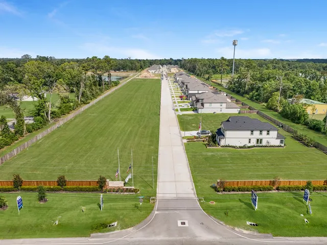 an aerial view of multiple houses with yard