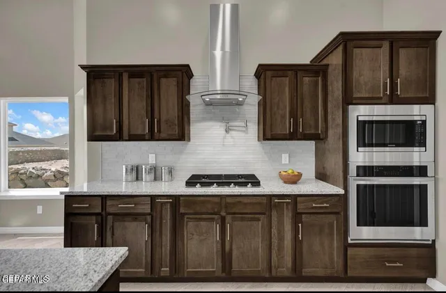 a kitchen with stainless steel appliances a stove and a microwave