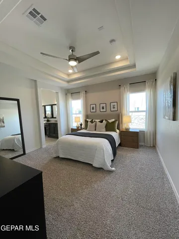 a bedroom with a large bed and a dresser