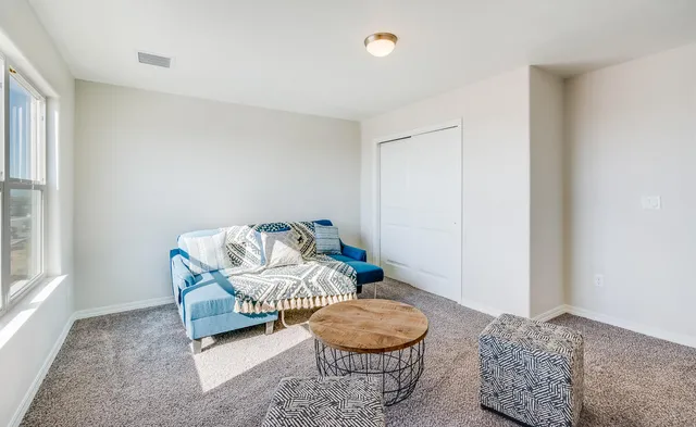 a living room with furniture and a window