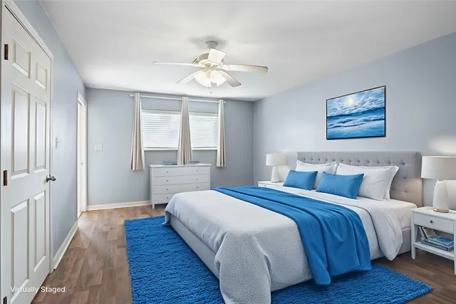 a bedroom with bed and wooden floor