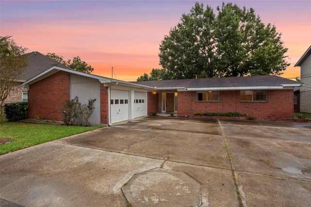 a view of a house with a yard and garage