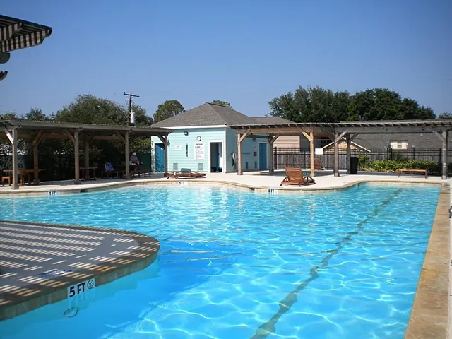 a view of a house with pool and a yard