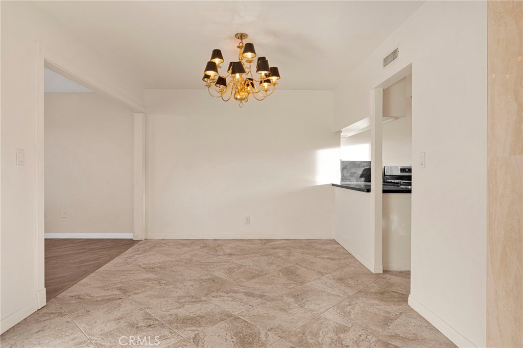 15177 Mendota Road North Apple Valley, CA 92307 - Photo 6 of 50 an empty room with a cabinet and a window
