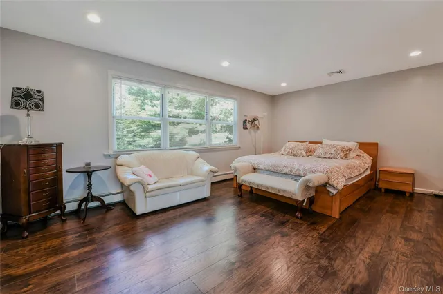 a bedroom with a bed and a couch