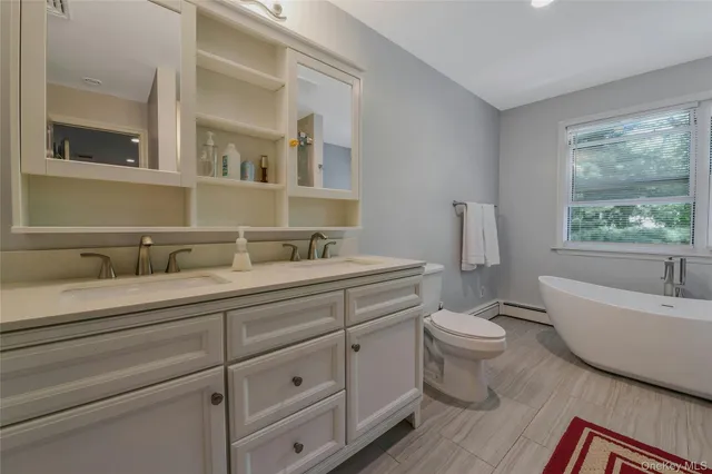 a spacious bathroom with a toilet a sink and a bathtub