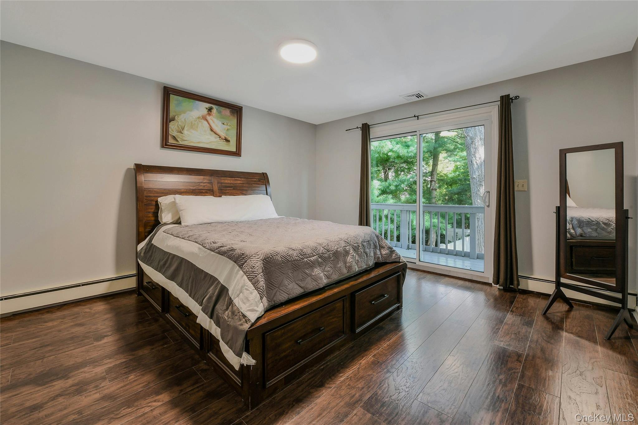 27 Upper Sheep Pasture Road East Setauket, NY 11733 - Photo 17 of 25 a bed sitting in a spacious bedroom next to a window