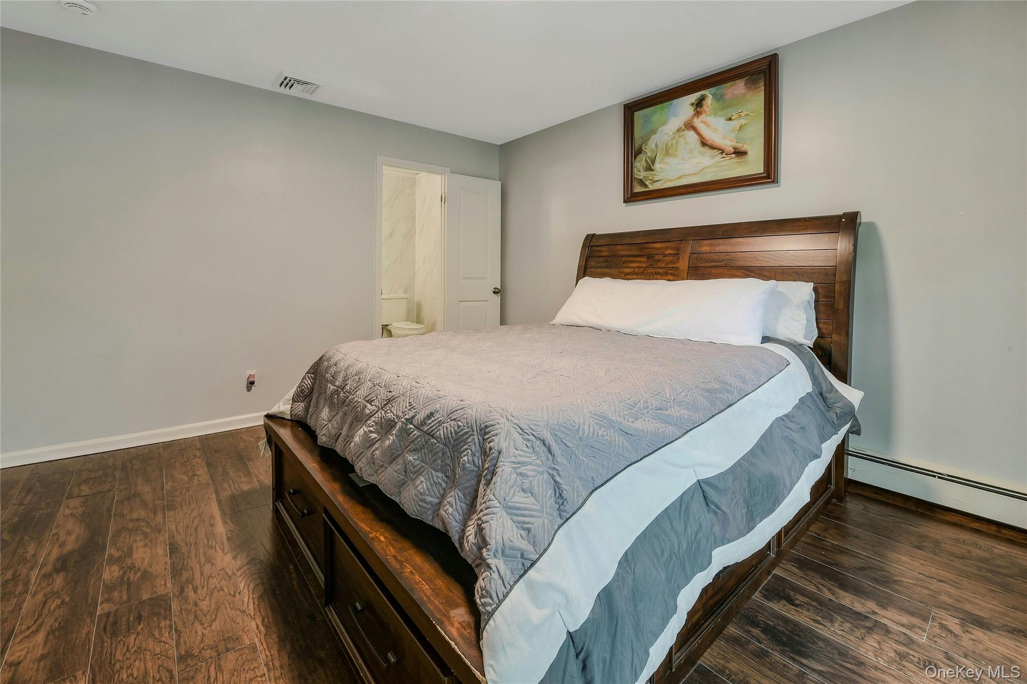 27 Upper Sheep Pasture Road East Setauket, NY 11733 - Photo 18 of 25 a bed sitting in a bedroom next to a wall