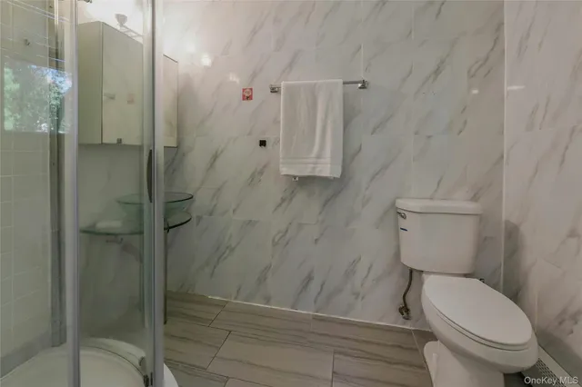 a bathroom with a toilet and shower