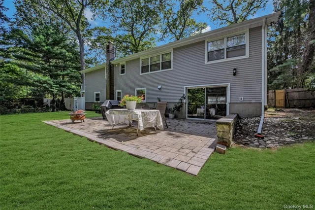 a view of a house with backyard and sitting area