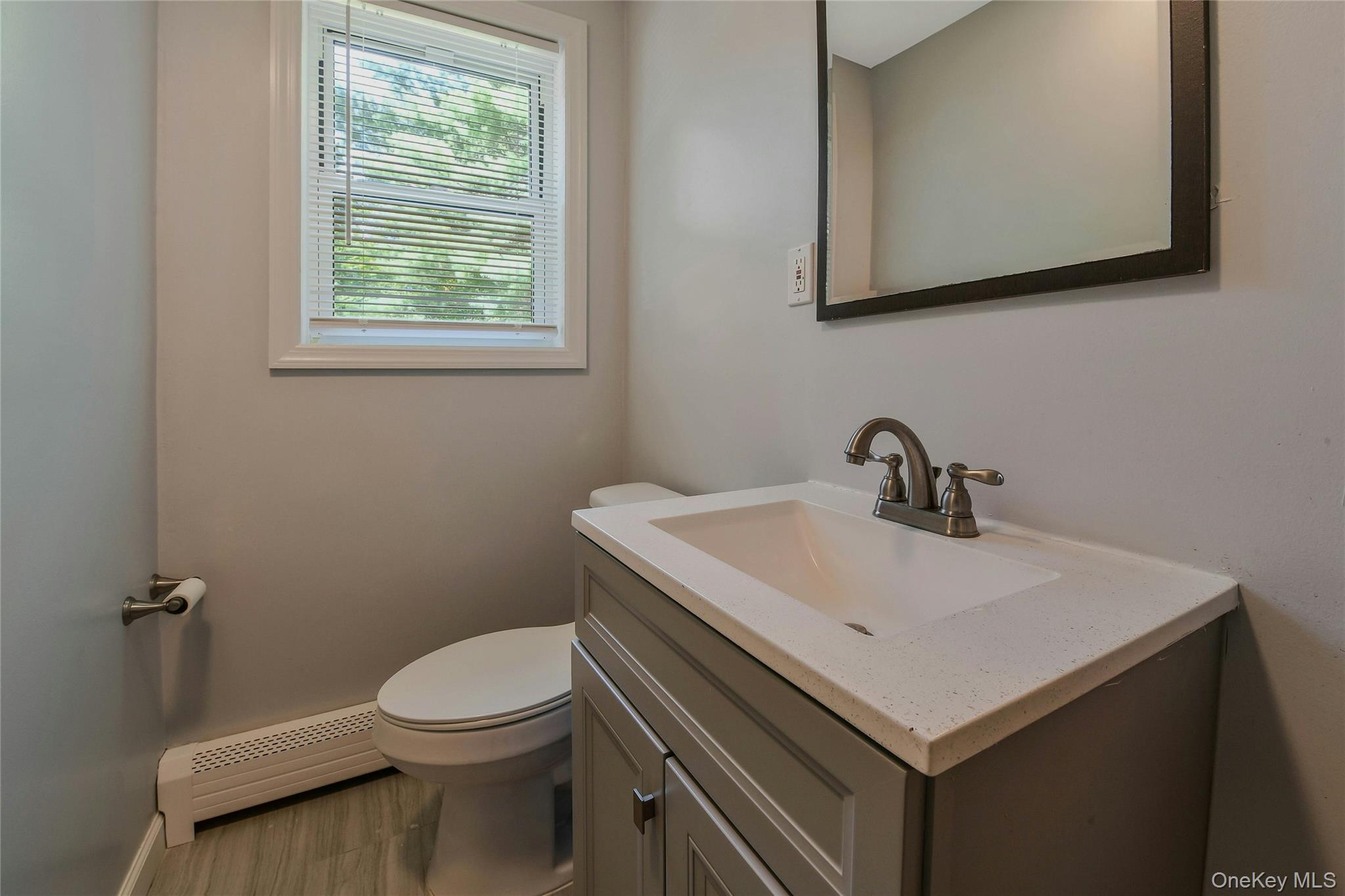 27 Upper Sheep Pasture Road East Setauket, NY 11733 - Photo 9 of 25 a white toilet sitting next to a bathroom sink