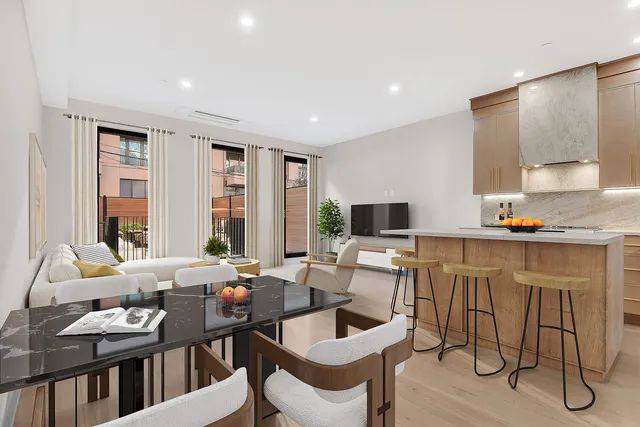 a kitchen with a table chairs refrigerator and cabinets